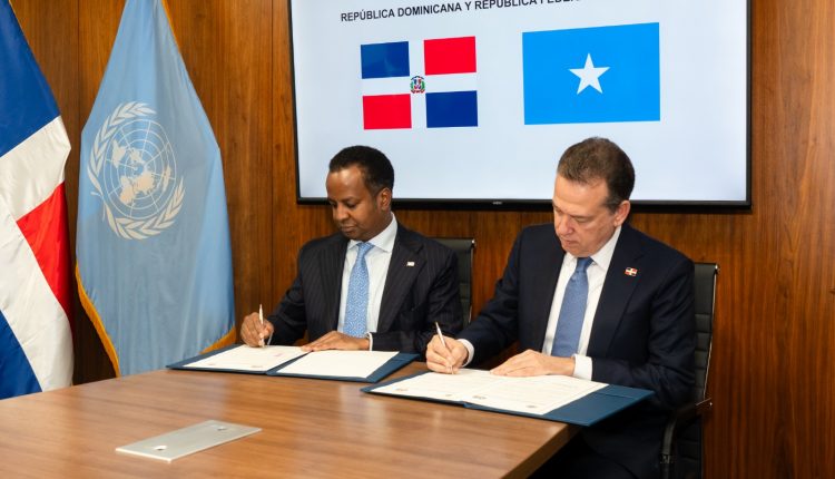 Abdisalam Abdi Ali, Ministro de Relaciones Exteriores y Cooperación Internacional de la República Federal de Somalia, firma junto a Víctor Bisonó.
